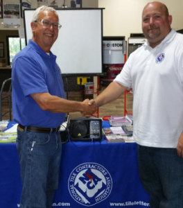 Michael Whistler hands the baton of being a NTCA technical trainer to Robb Roderick at Whistler’s last NTCA workshop at the Livermore, Calif. Daltile.