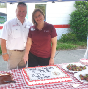 Owners Nyle Wadford and Paige Wadford Smith cut the cake at a celebration of Neuse Tile’s more than 50 years of service.