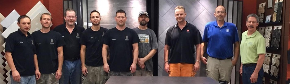 At Sark Tile, Lincoln, Neb., are (l. to r.): Oleg Ketrar; Tyson Skinner; John Calderwood; Tim Hufman; Randy Stroud; James Chamberlain – all of Rainwood Interiors; Mark Becher (owner of Sark Tile); Dan Hecox; and Scott Carothers.