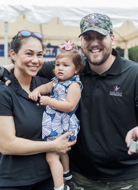 Marine Sgt. Frazier with wife Monica and daughter Sophia at the groundbreaking. The couple is expecting a second child soon.